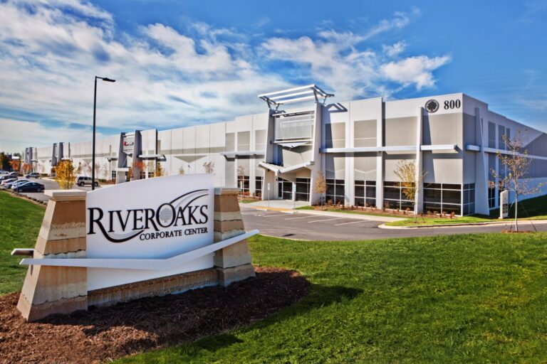 Modern building with the sign "River Oaks Corporate Center" in the foreground.